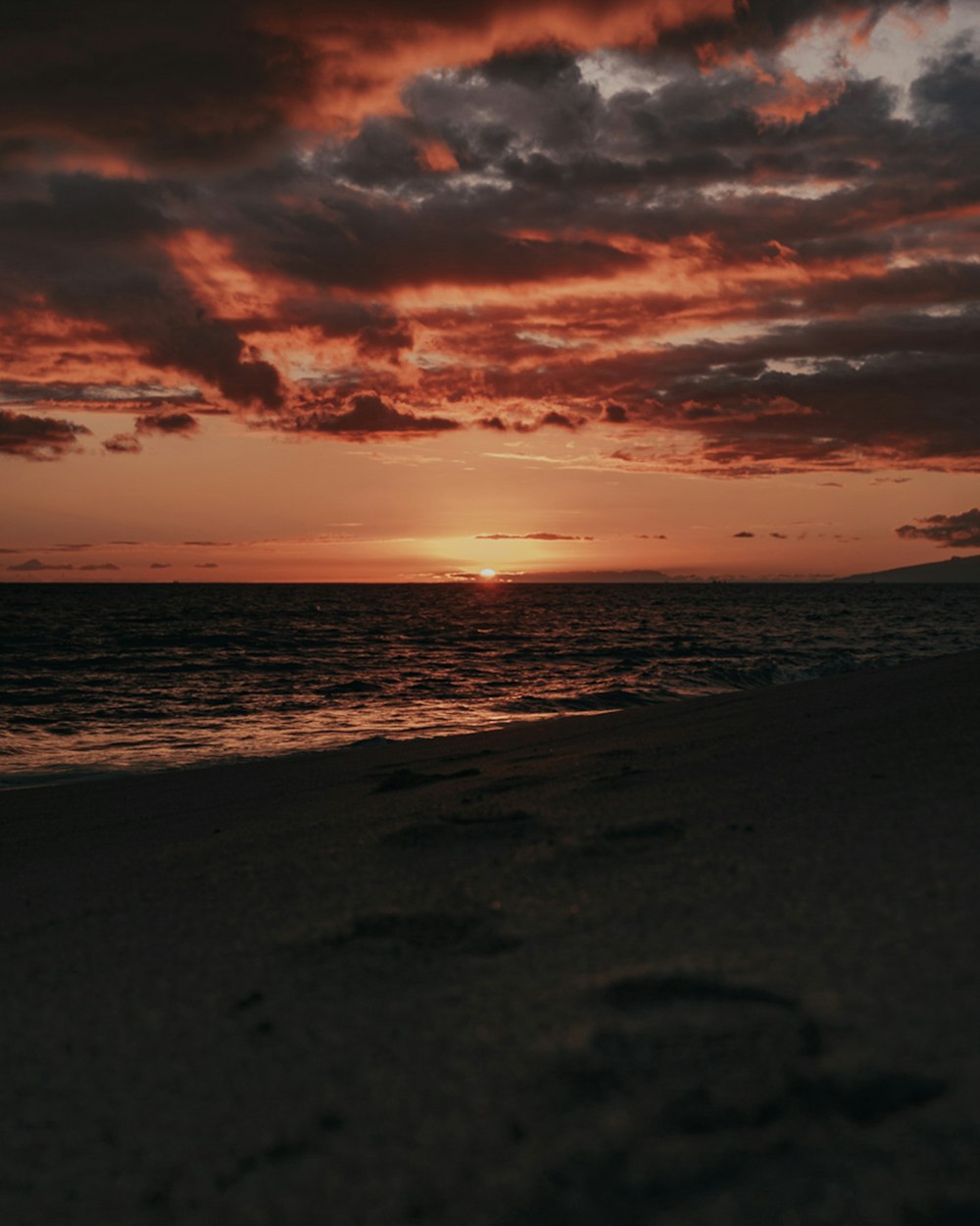 sea waves crashing on shore during sunset