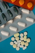 white oval medication pill on blue surface