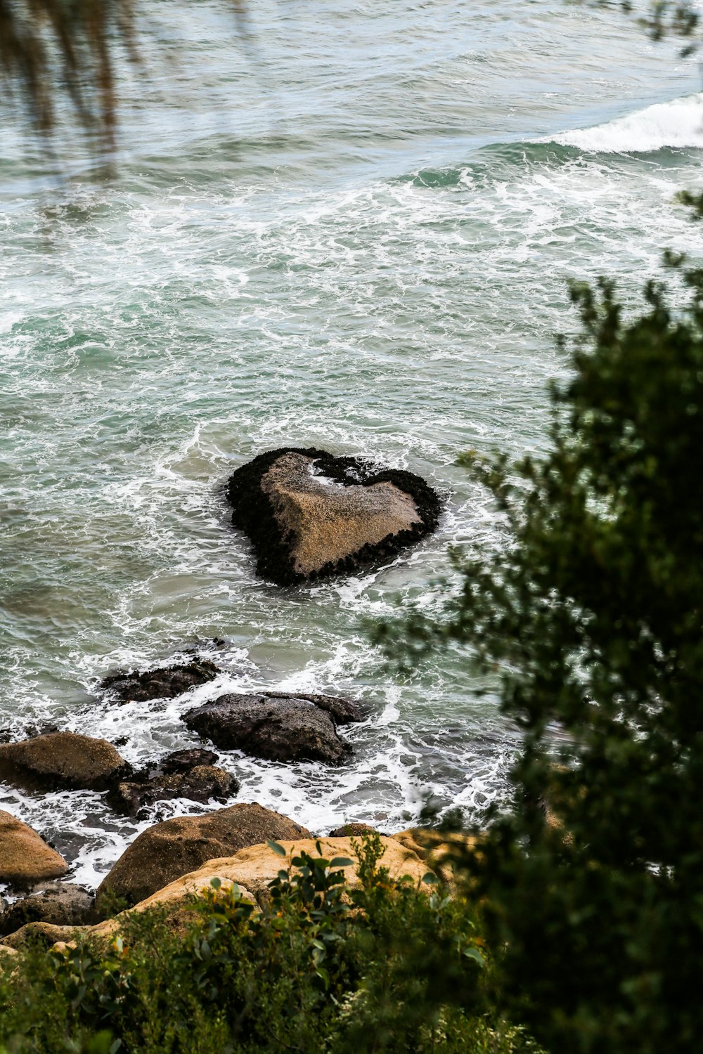 brown rock formation on sea during daytime