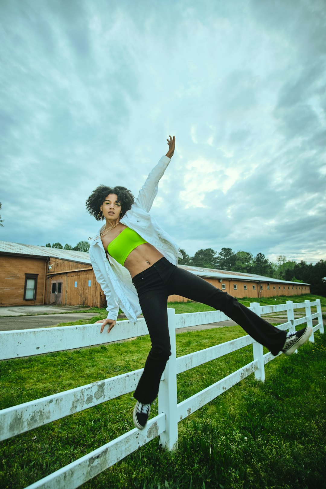 woman in white tank top and black leggings doing yoga during daytime