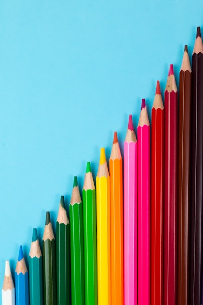 multi colored pencils on blue background