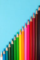 multi colored pencils on pink background