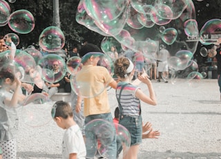 a group of children playing with soap bubbles