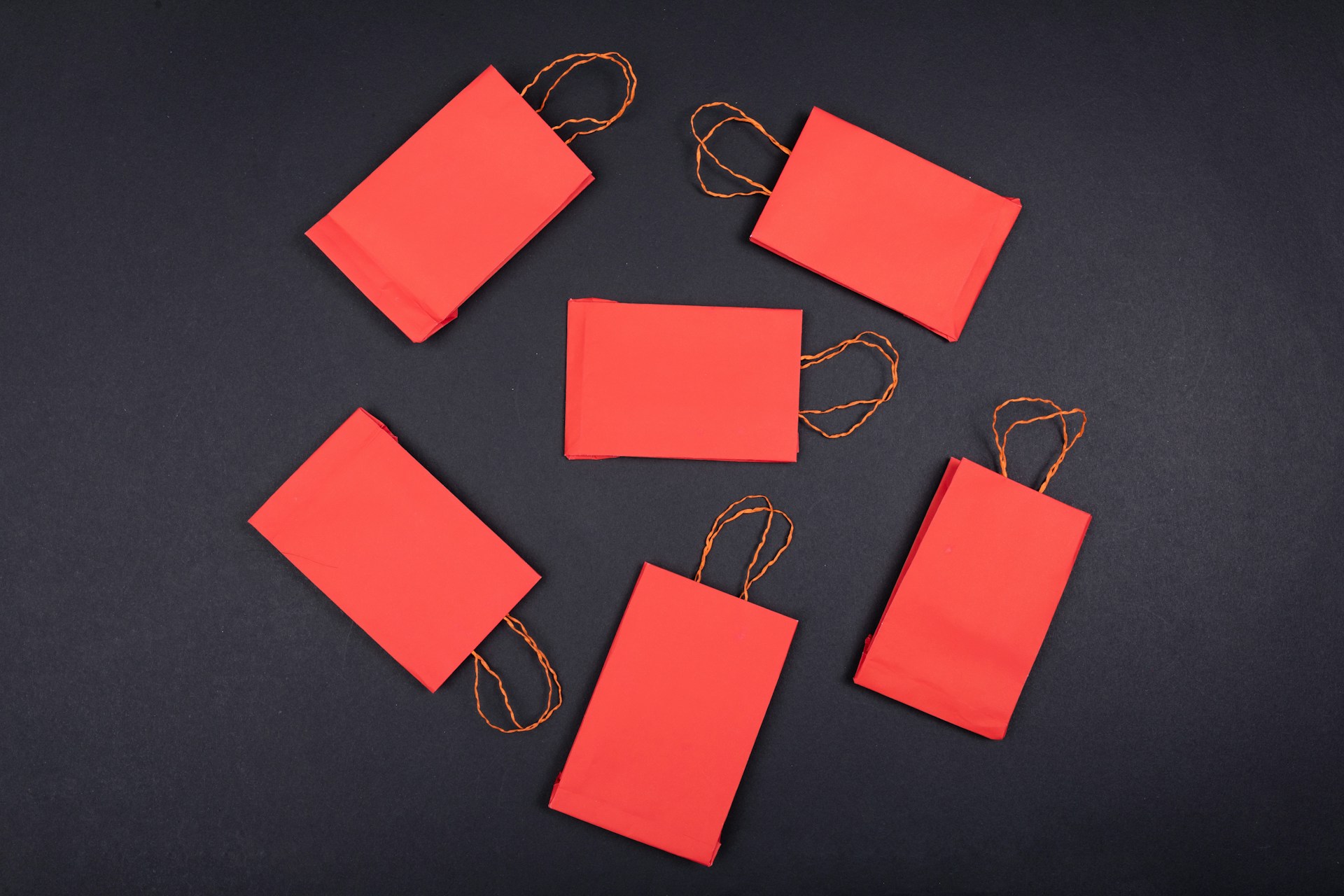 orange paper clip on black surface