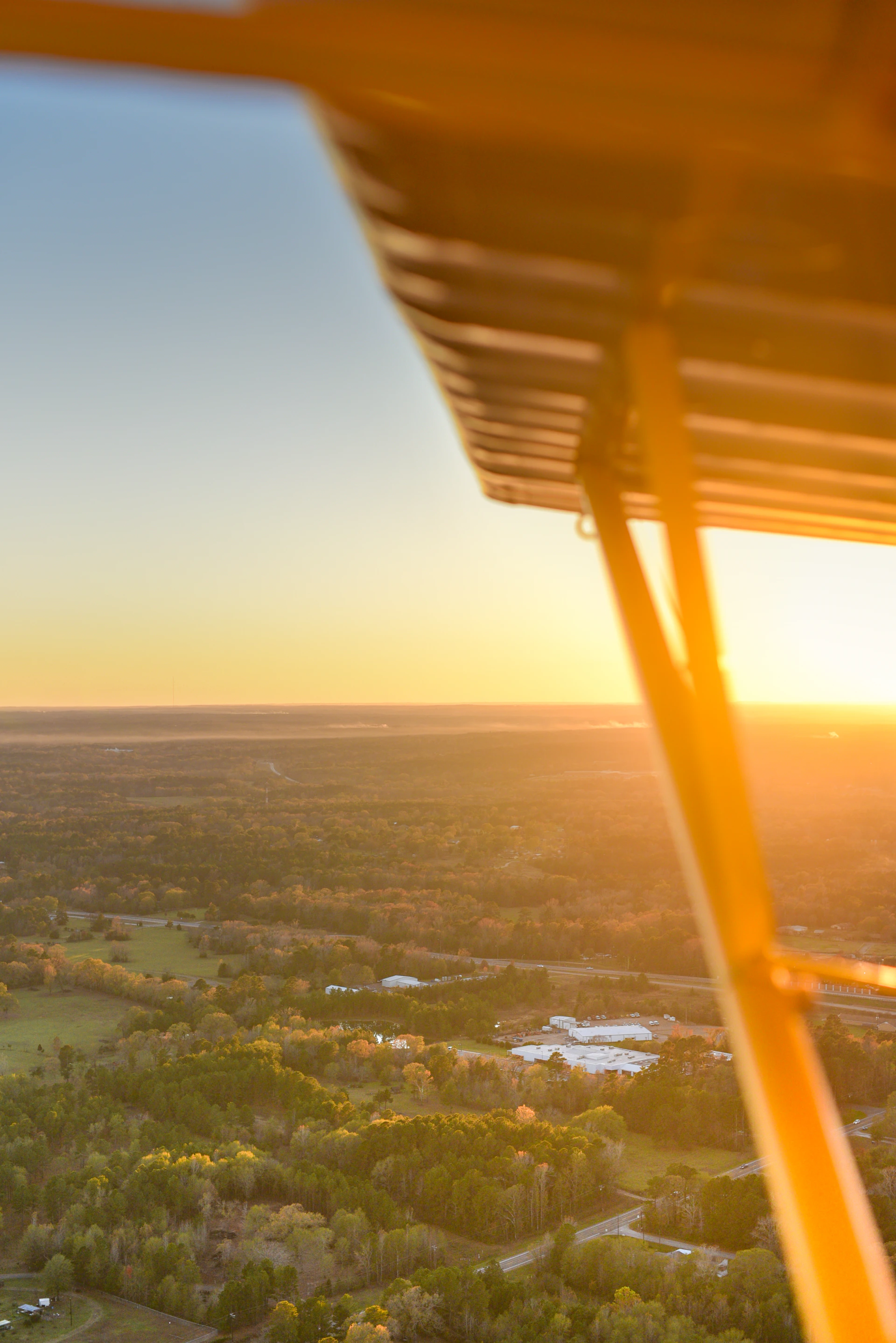A stunning aerial shot of Bogor's lush green landscapes captured at golden hour, highlighting the vibrant colors and serene atmosphere.