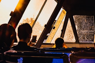 A happy family enjoying a ride in a spacious vehicle with city views.