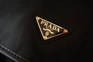 a prada logo on a black jacket