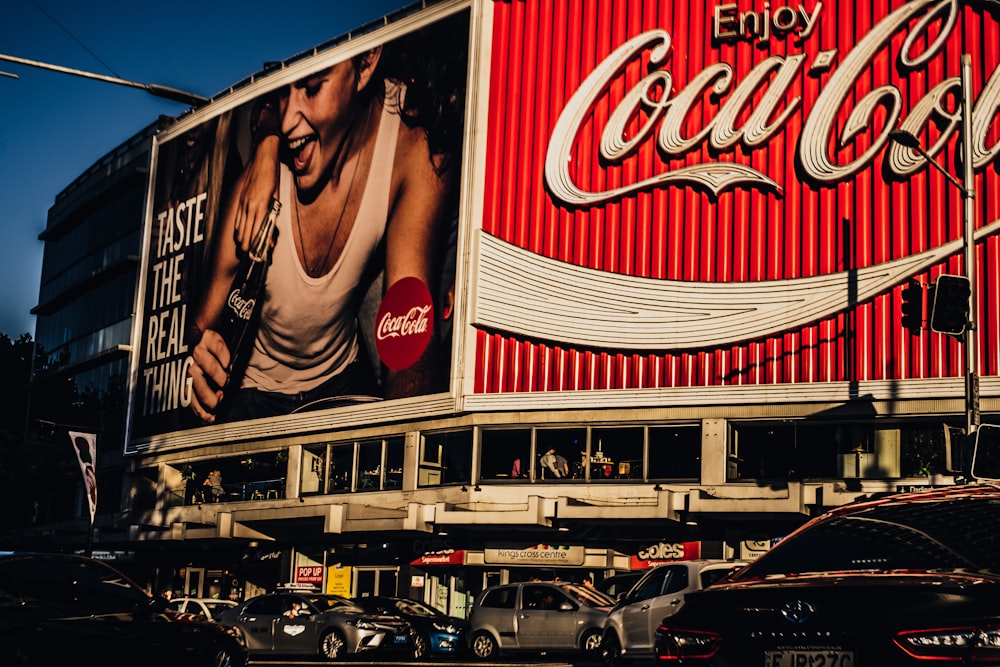 coca cola signage on top of black car