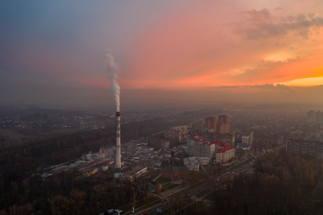 city with high rise buildings under orange sky