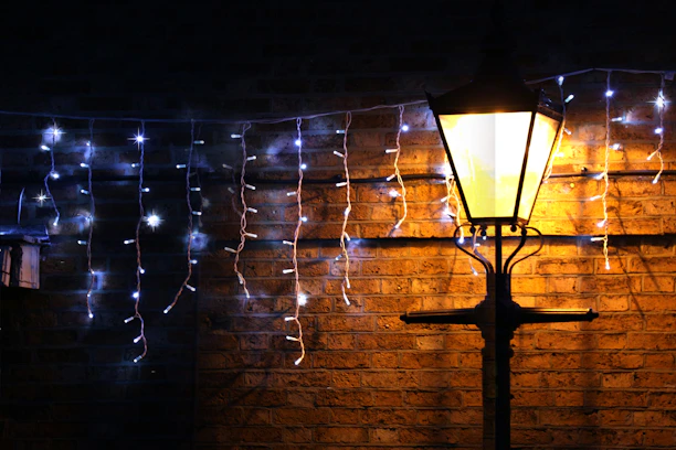 A decorative garden wall creating a private nook with soft lighting in the evening.