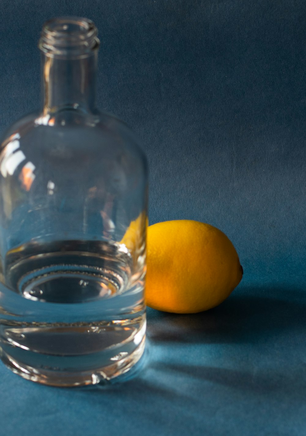 clear glass bottle with yellow lemon