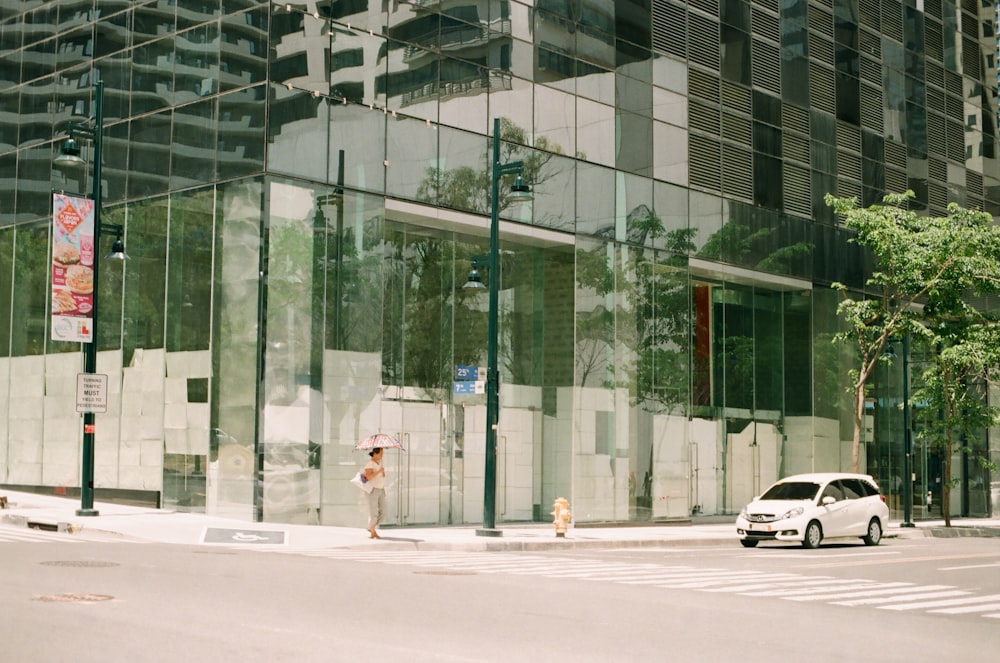 white car on road near building during daytime