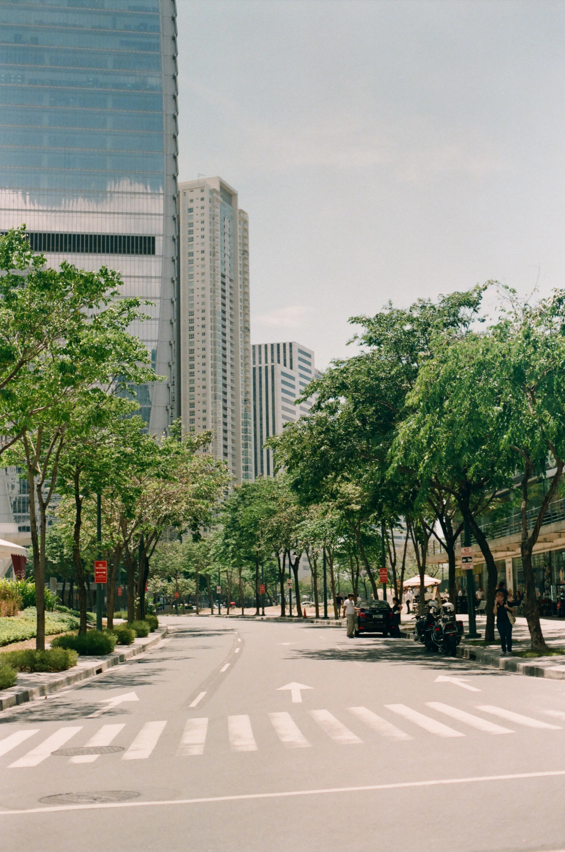 A city street with tall buildings in the background