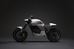 white and black motorcycle with black background
