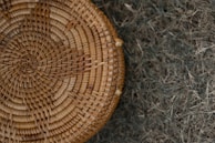 Close-up of a handwoven basket sitting on a reclaimed wood table.