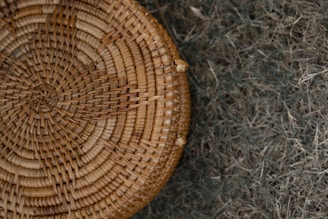 Close-up of woven wicker baskets resting on a warm beige linen cloth.