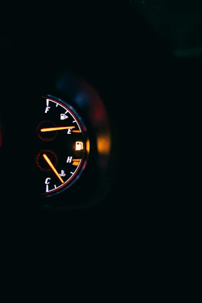 Close-up of a car dashboard showing the gas vehicular system indicator lit up.