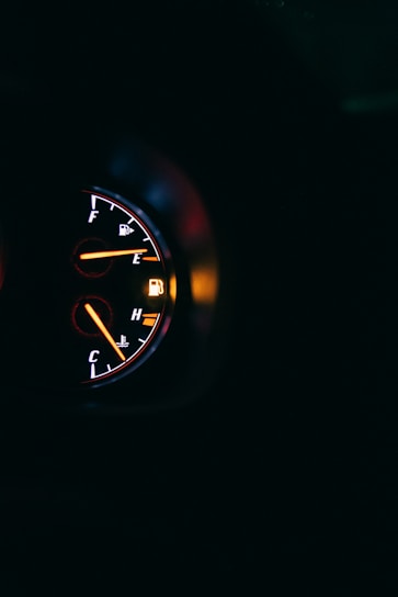 A close-up of a fuel gauge showing low levels, symbolizing fuel efficiency.