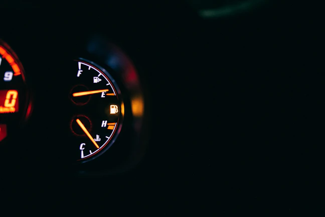 Close-up of a car dashboard showing the gas vehicular system indicator lit up