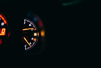 A modern car dashboard illuminated in soft yellow gold tones.