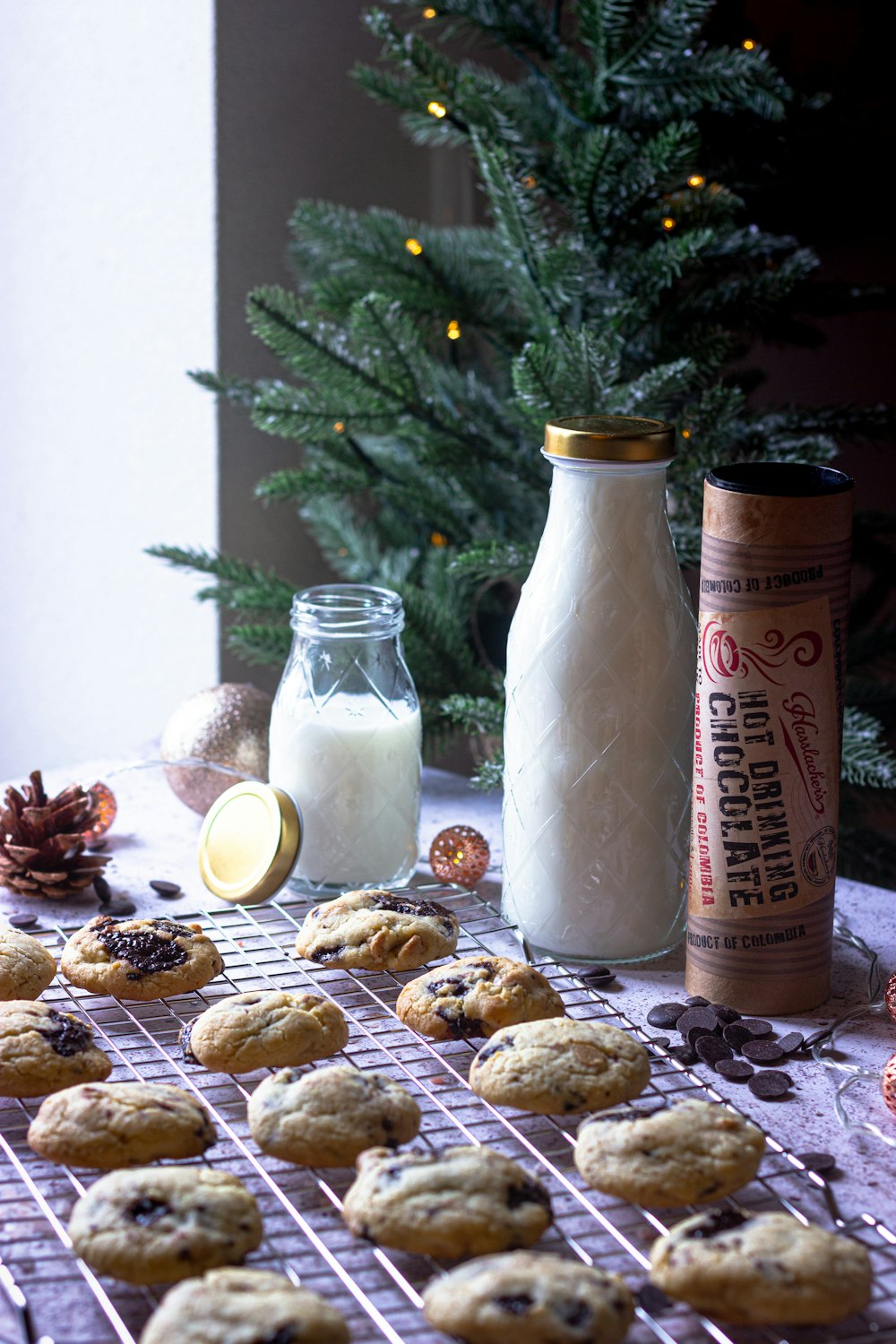 milk in clear glass jar beside cookies and cookies