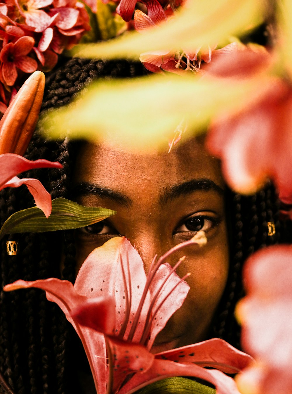 woman in black and yellow shirt with pink flower on her face