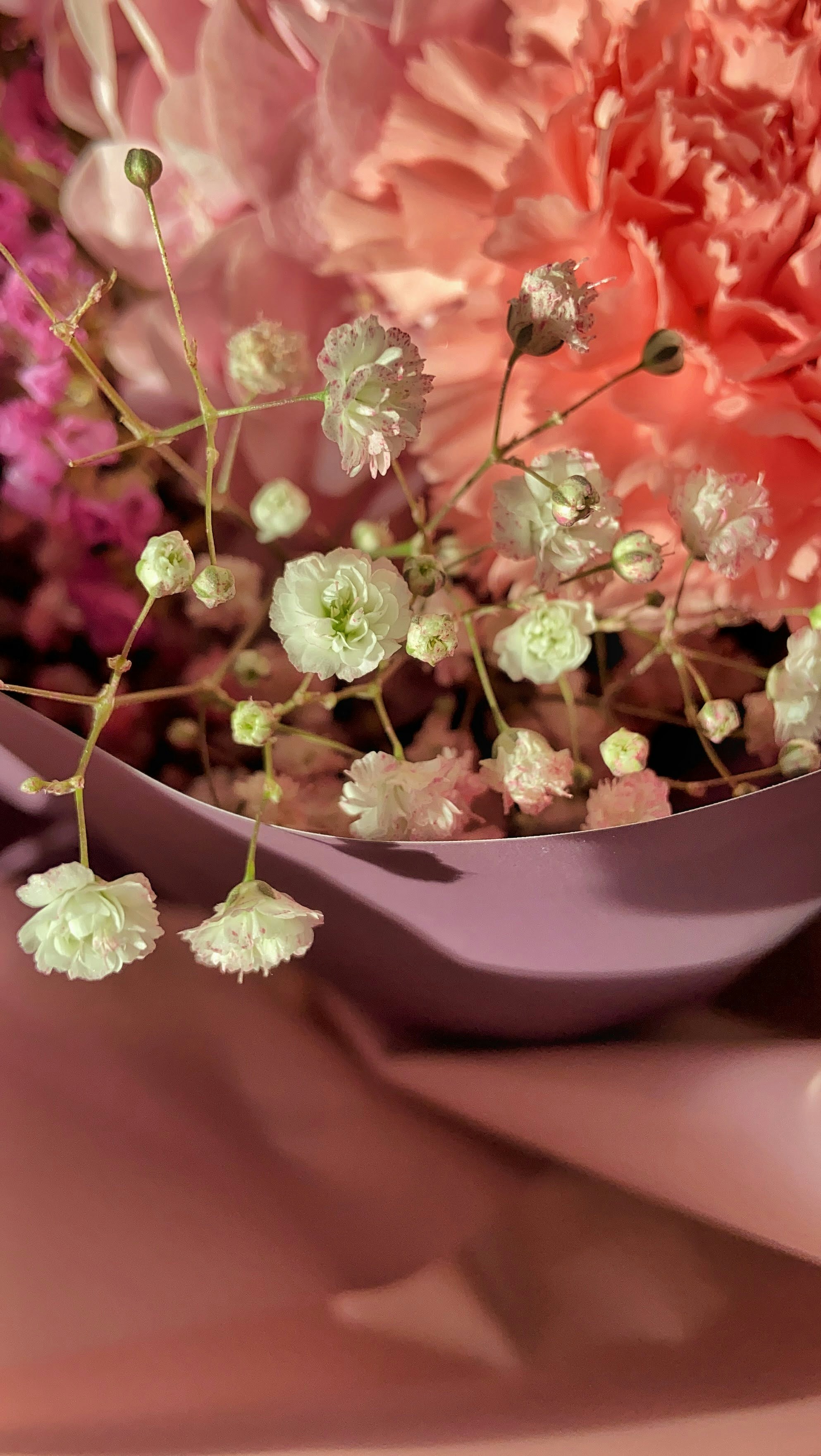 Elegant mixed garden flowers in soft pink and purple tones for a party setting
