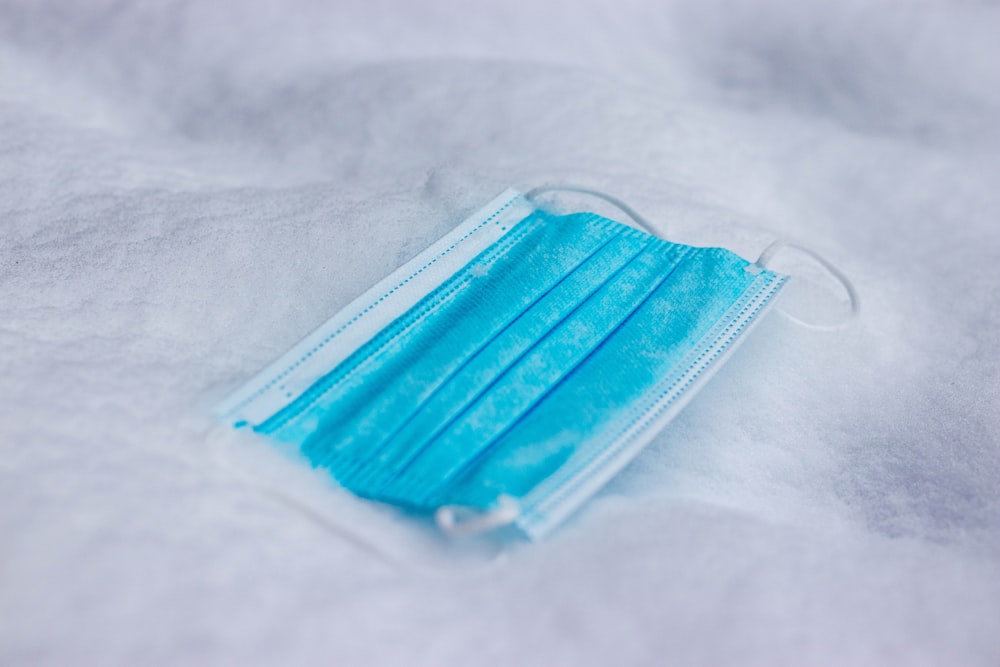 teal plastic pack on white textile