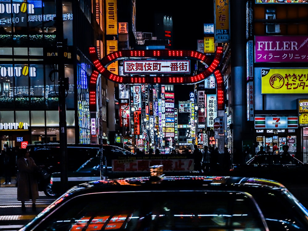 cars on road near buildings during night time