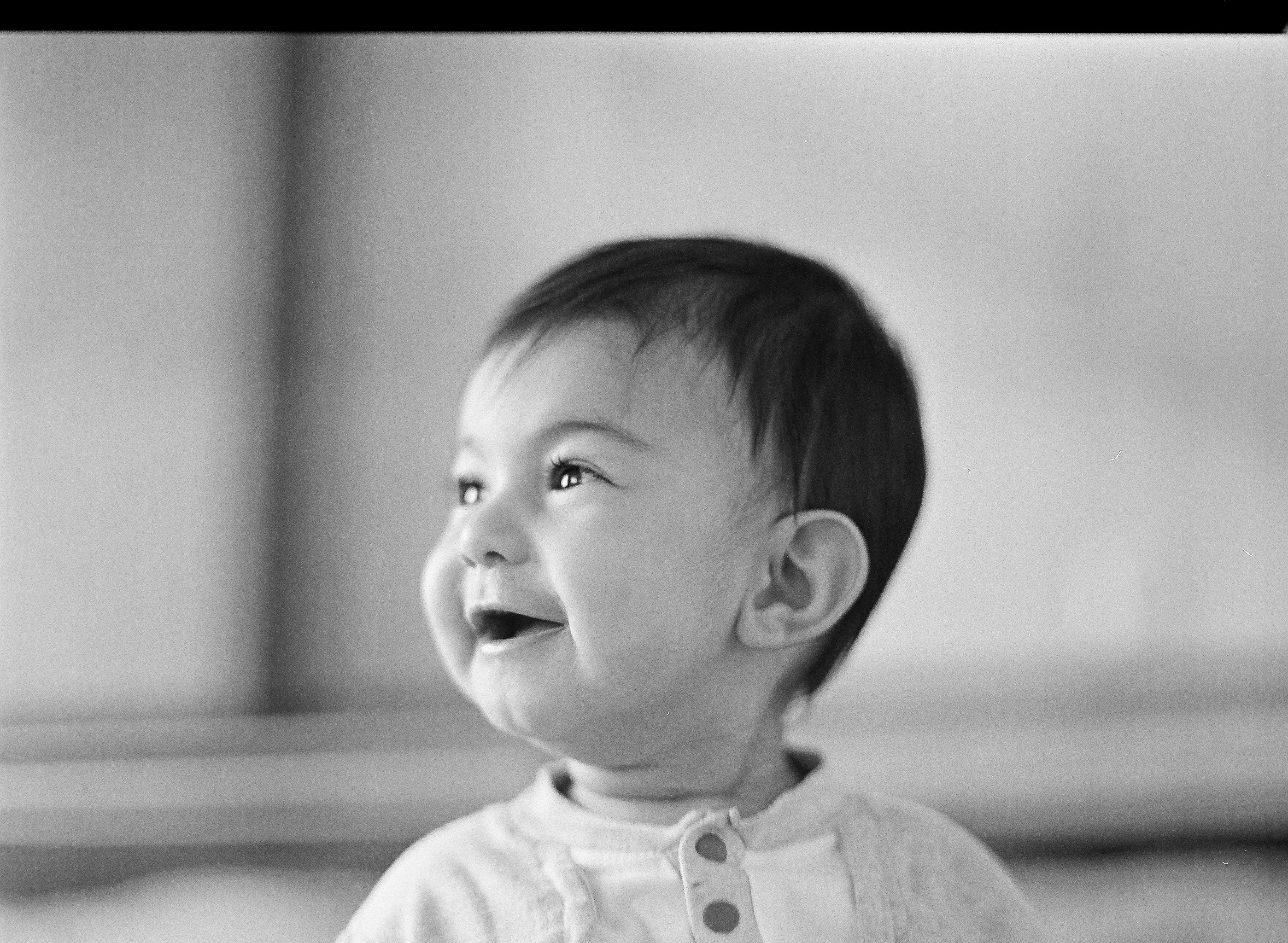 grayscale photo of child in button up shirt