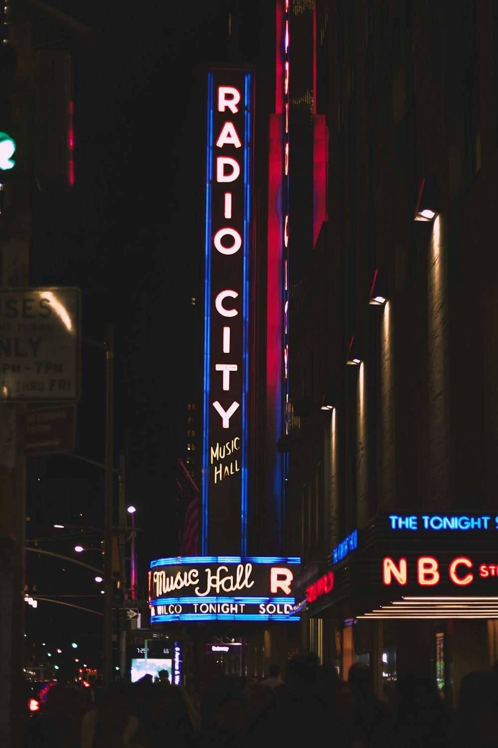 the radio city sign is lit up at night