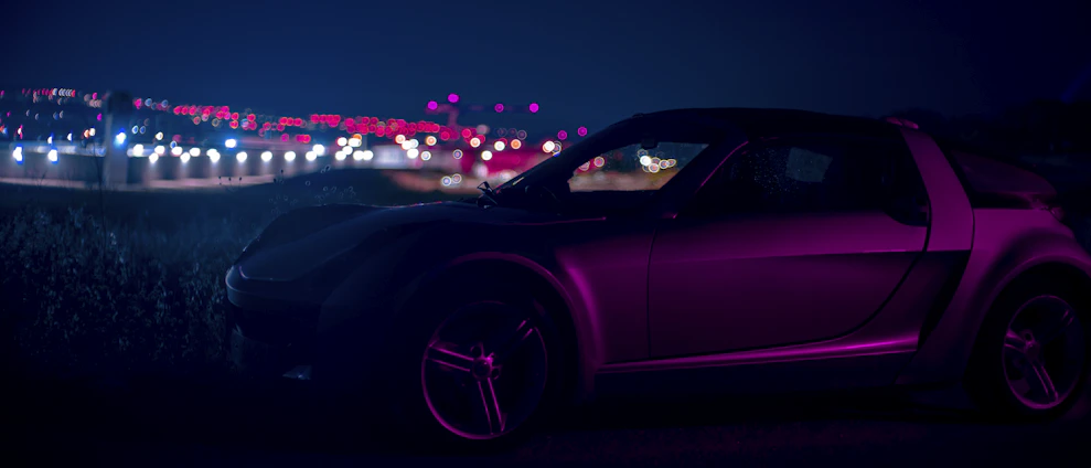 A sleek car gleaming under neon pink and blue lights, with a retro synthwave cityscape in the background.