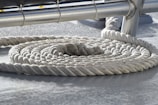 Dyneema ropes coiled neatly beside a yacht mast ready for rigging