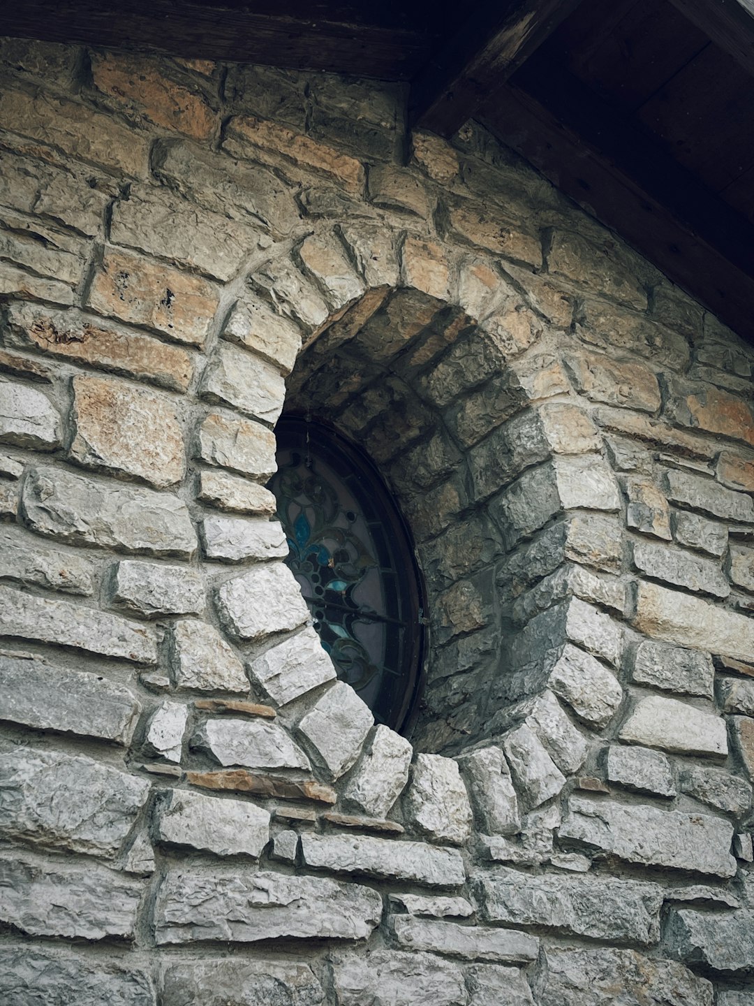 grey brick tunnel with blue glass window