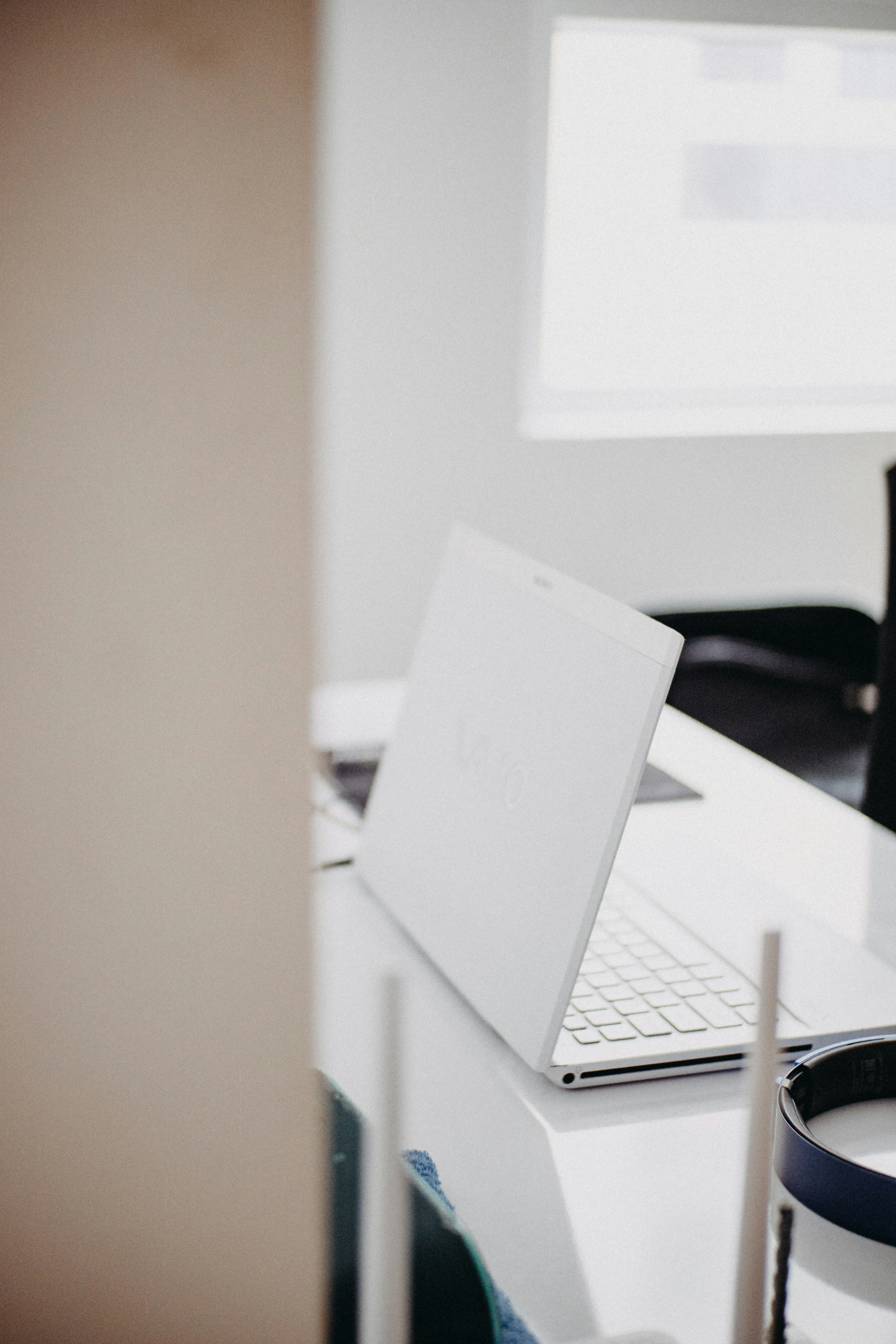 silver macbook on white table
