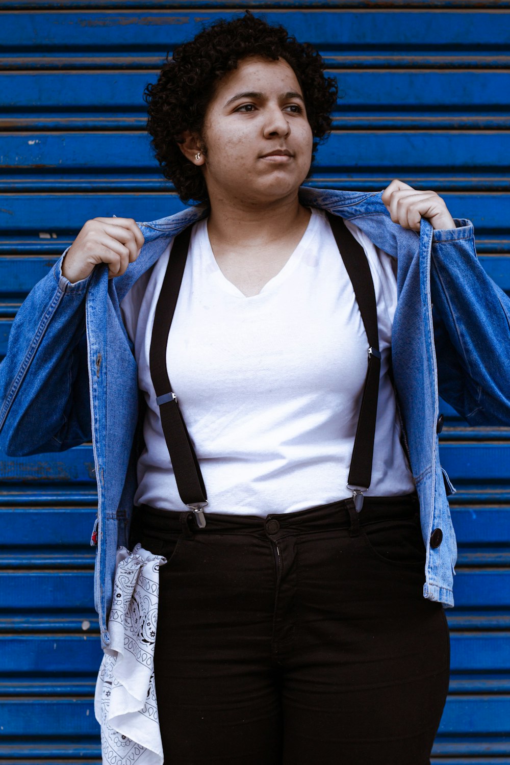 woman in white tank top and blue jacket