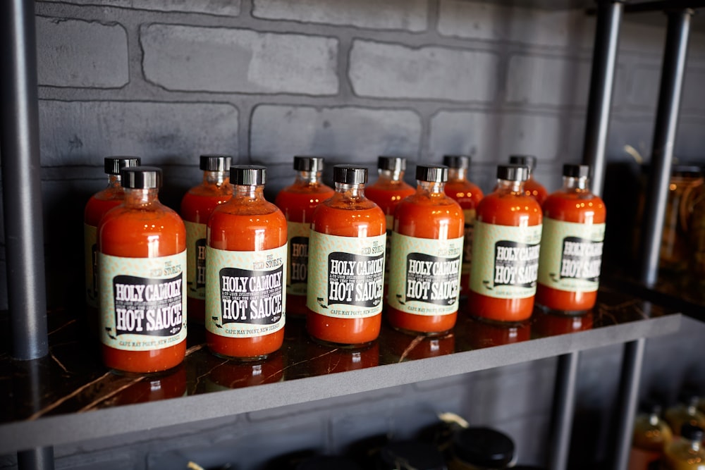 orange plastic bottles on gray metal rack