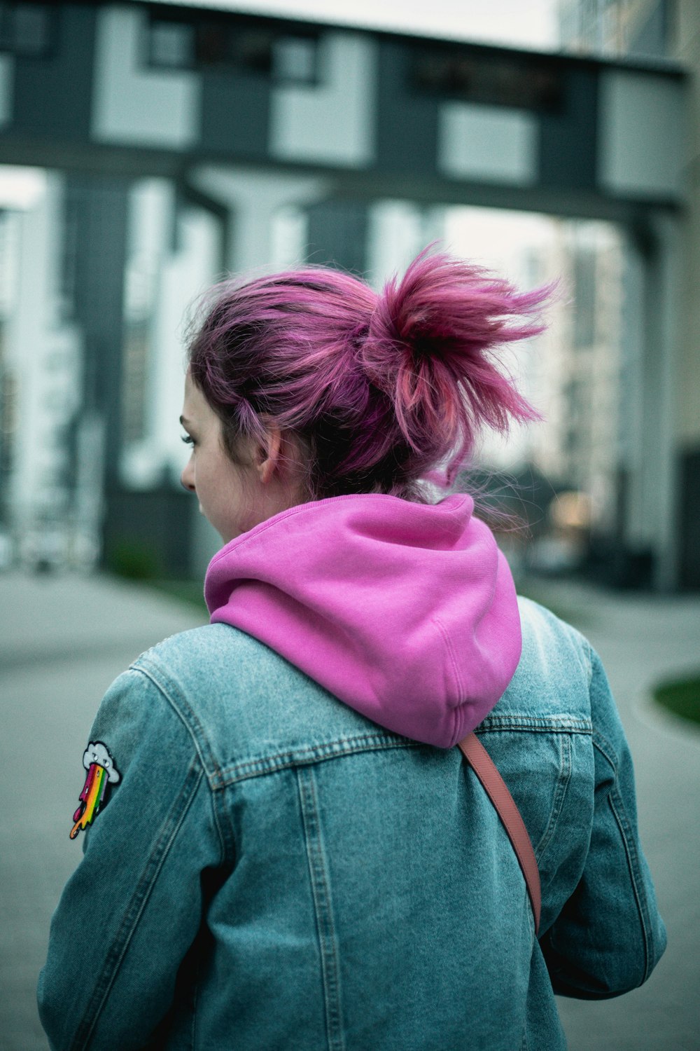 woman in pink hoodie and blue denim jacket