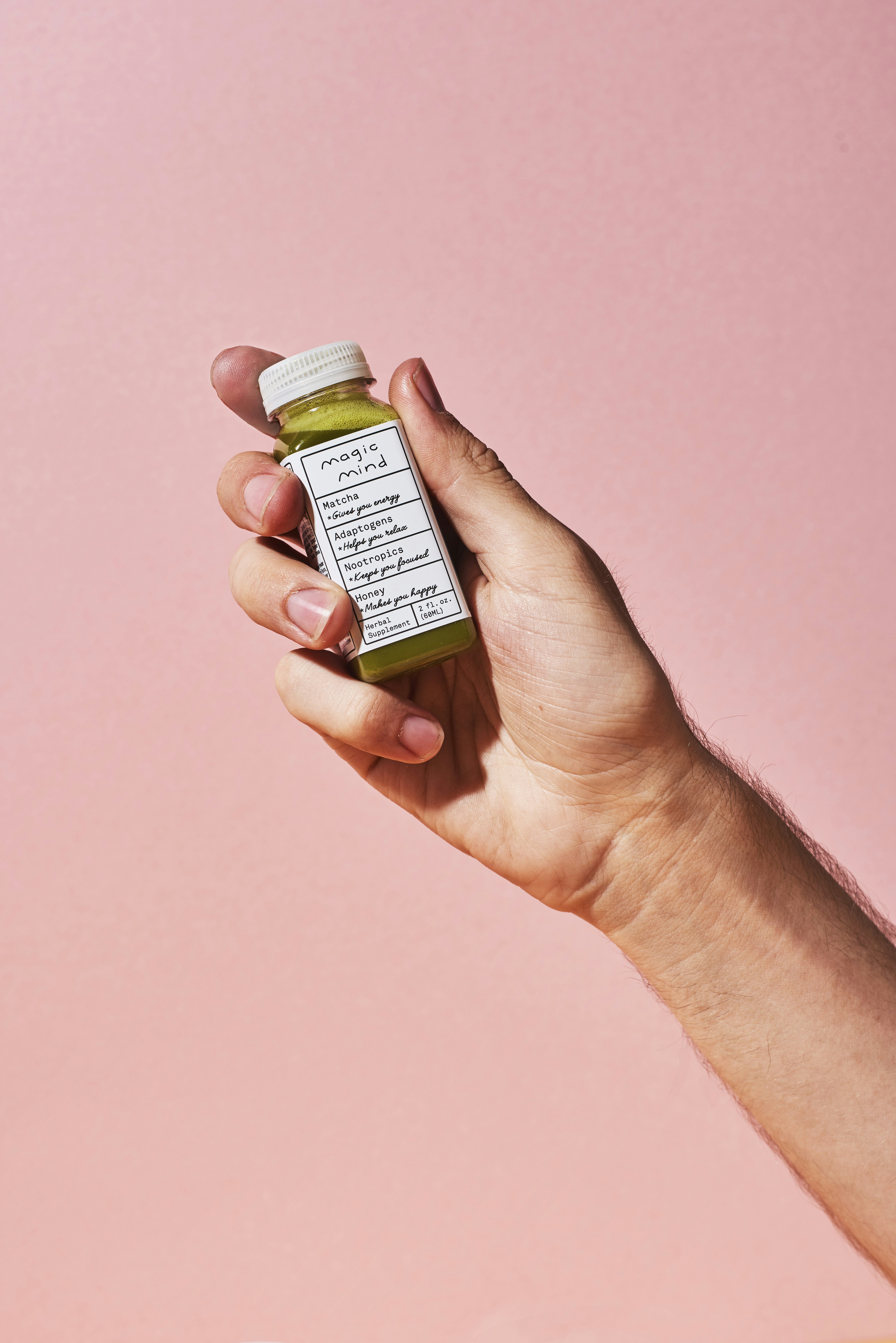 person holding white labeled bottle