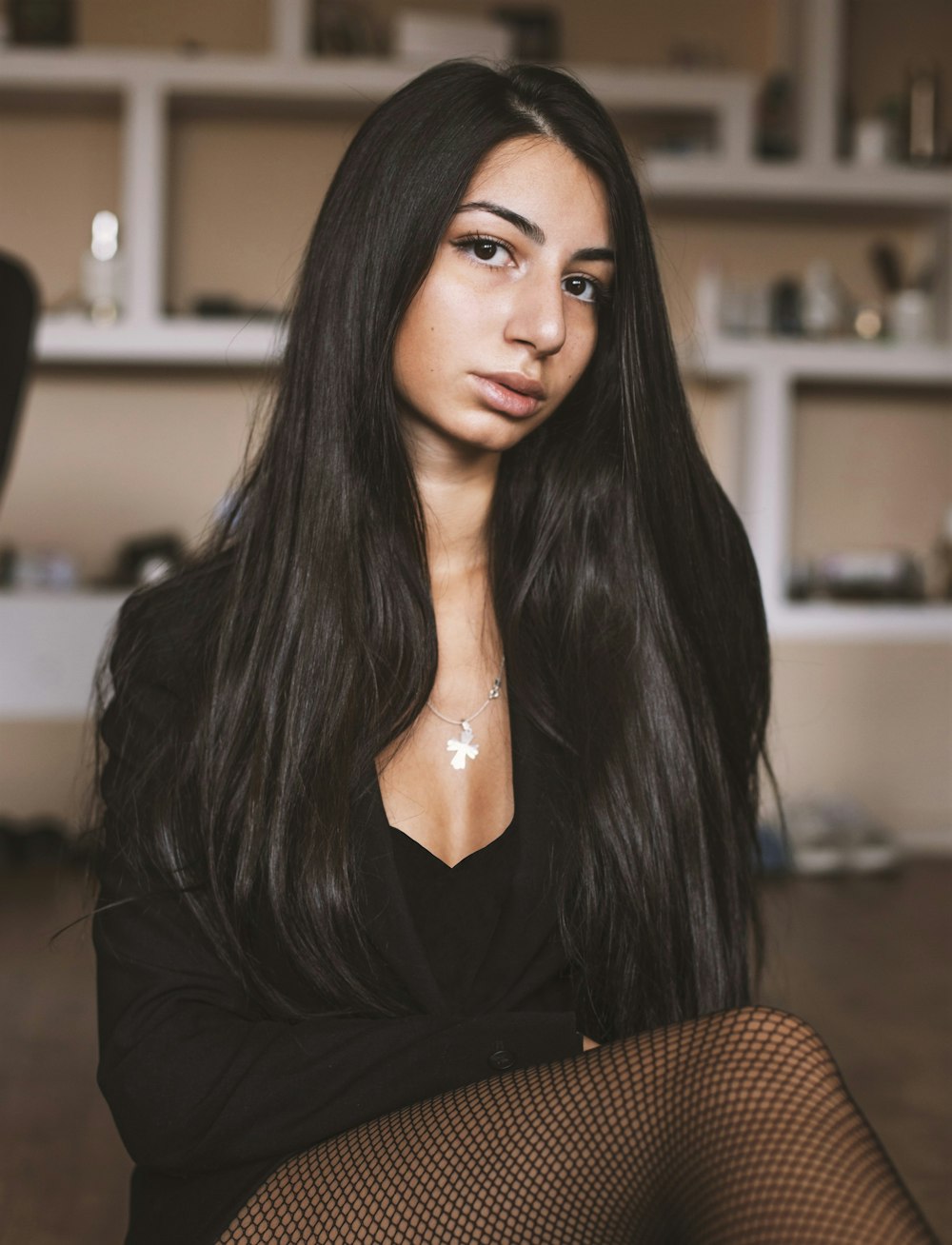 woman in black long sleeve shirt sitting on brown chair