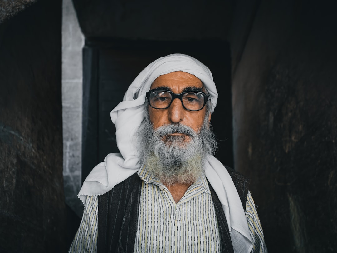 man in white turban and black and white striped shirt