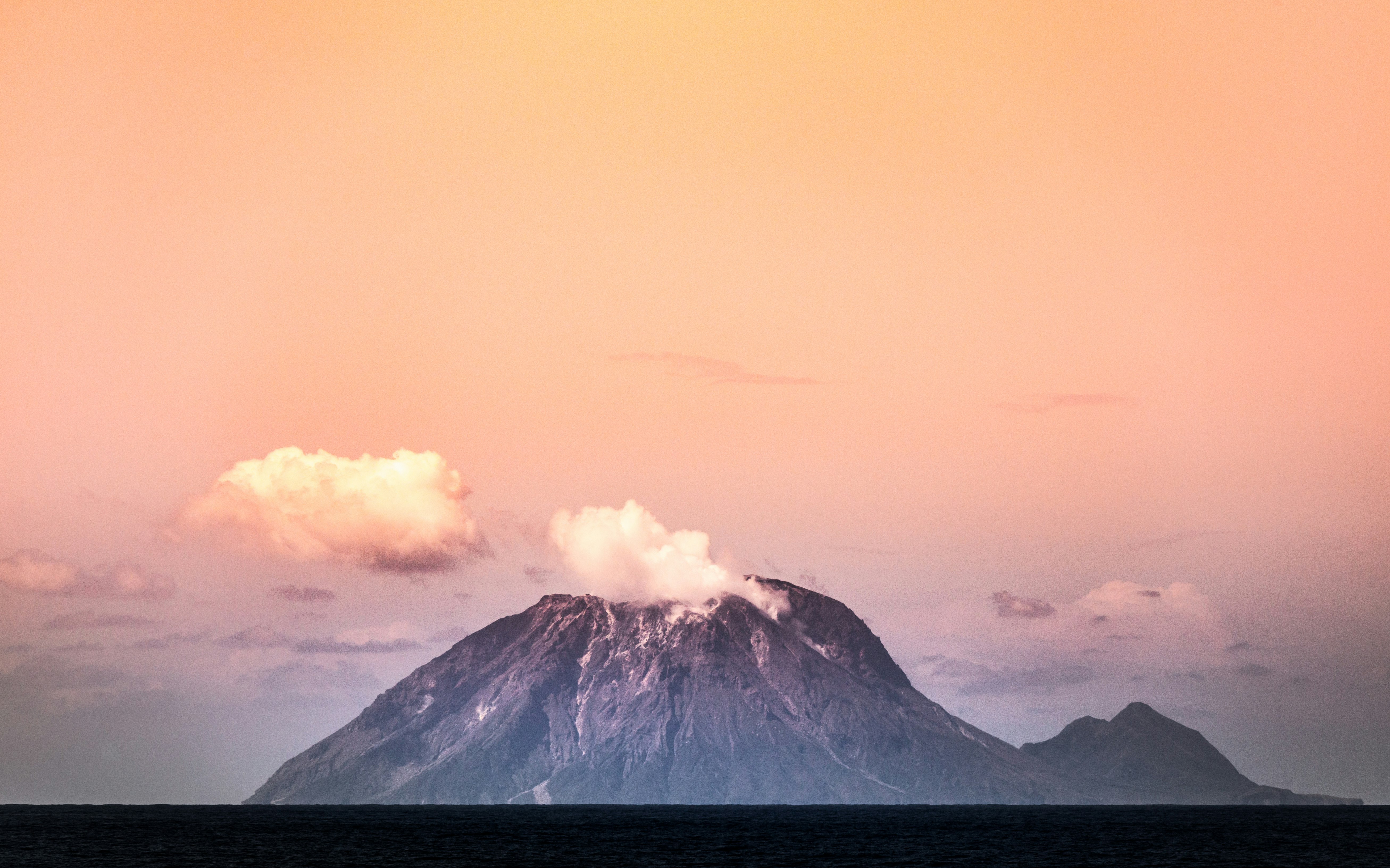 white clouds over snow covered mountain