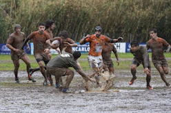 men running on dirt road during daytime