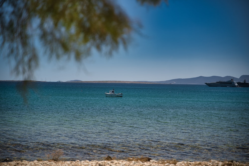 white boat on sea during daytime