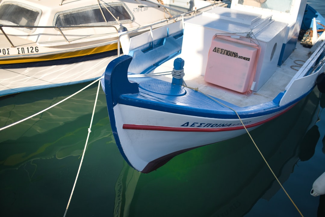 red and white boat on body of water during daytime