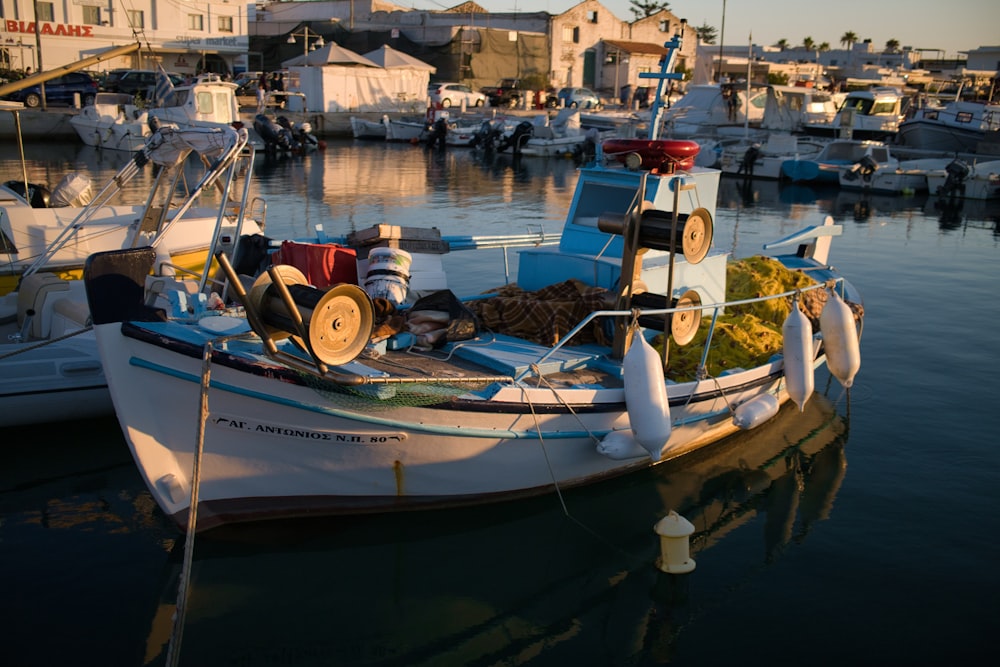 white and blue boat on water during daytime