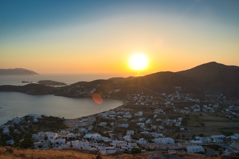 city near body of water during sunset