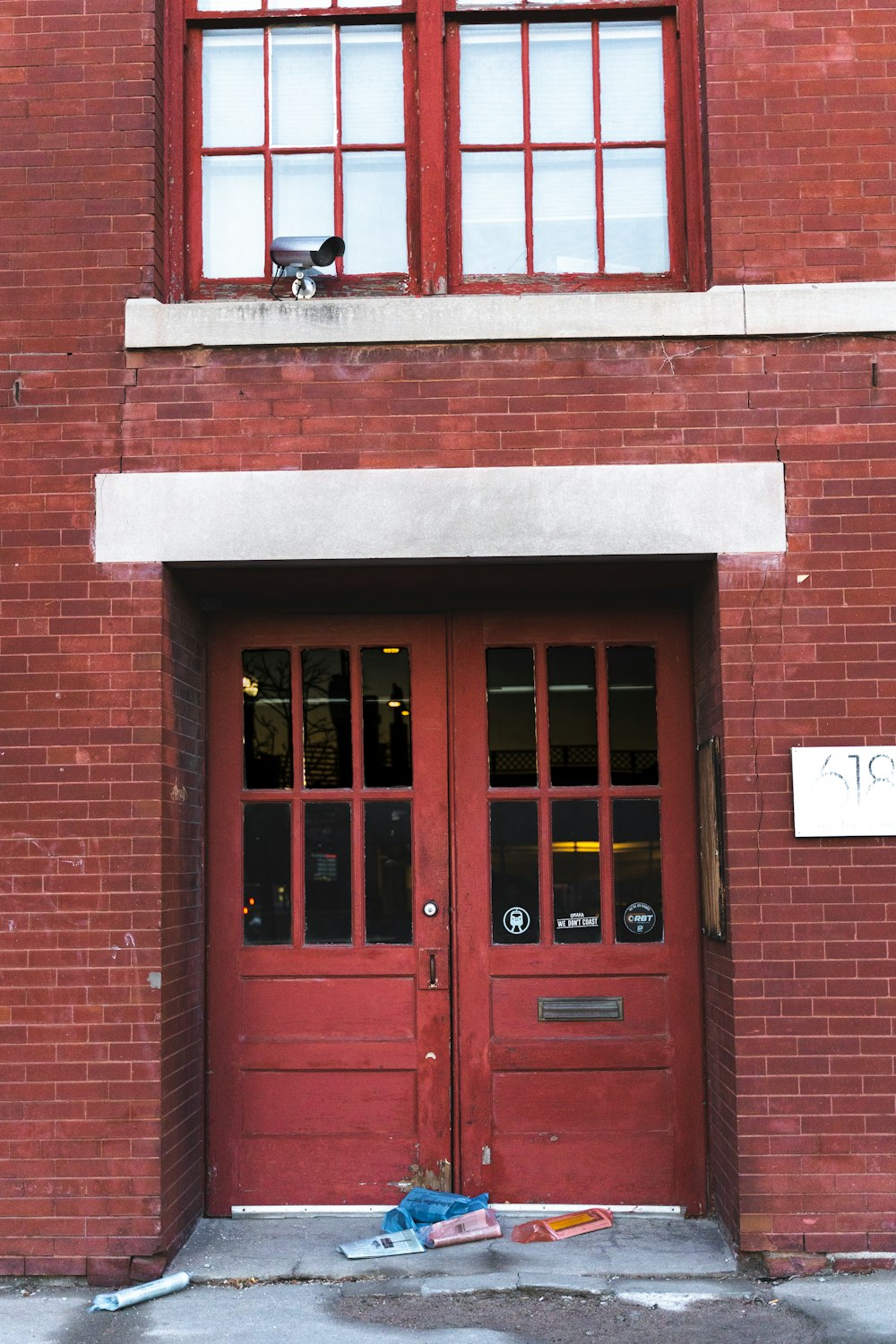 red wooden door on brown brick building