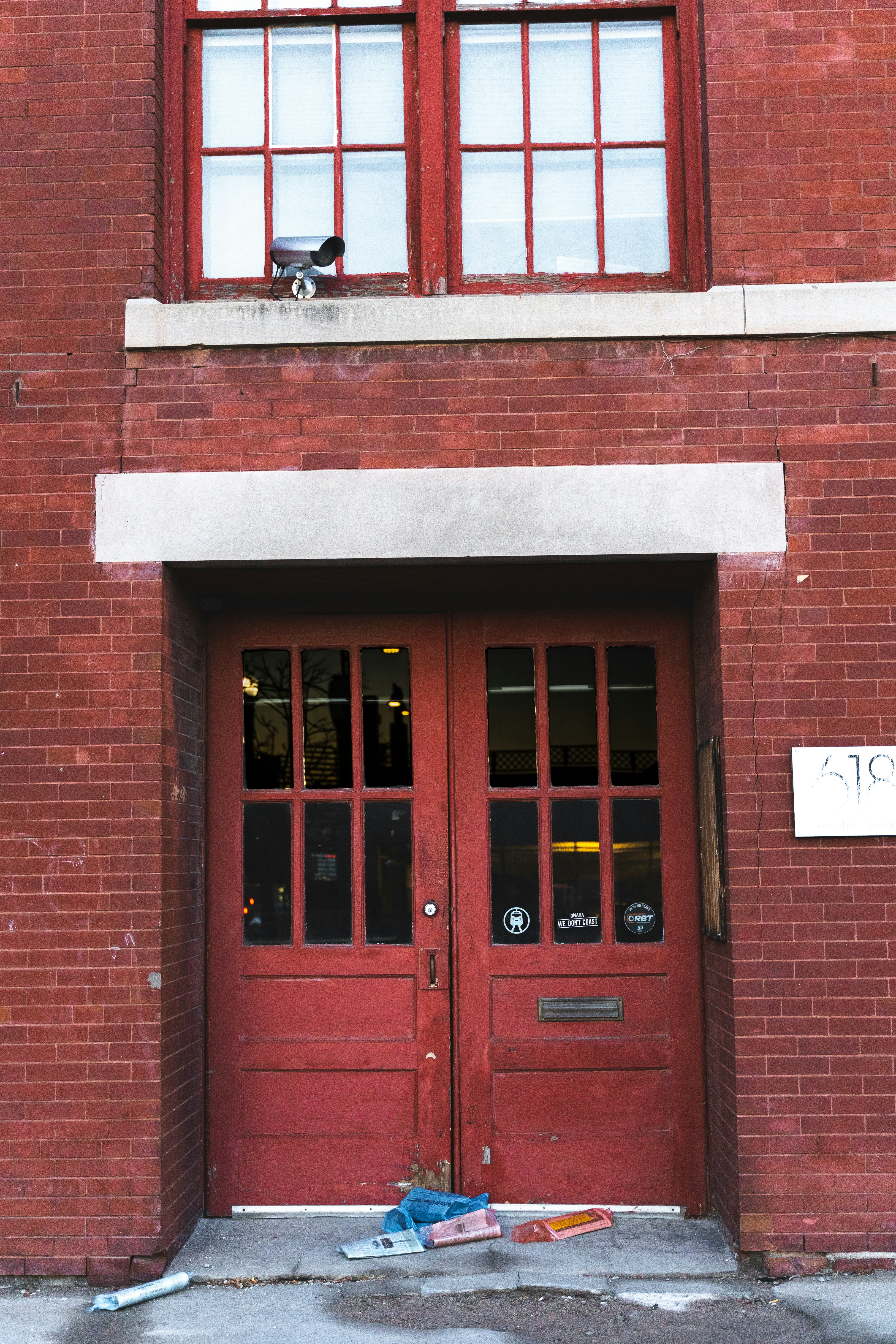 red wooden door on brown brick building