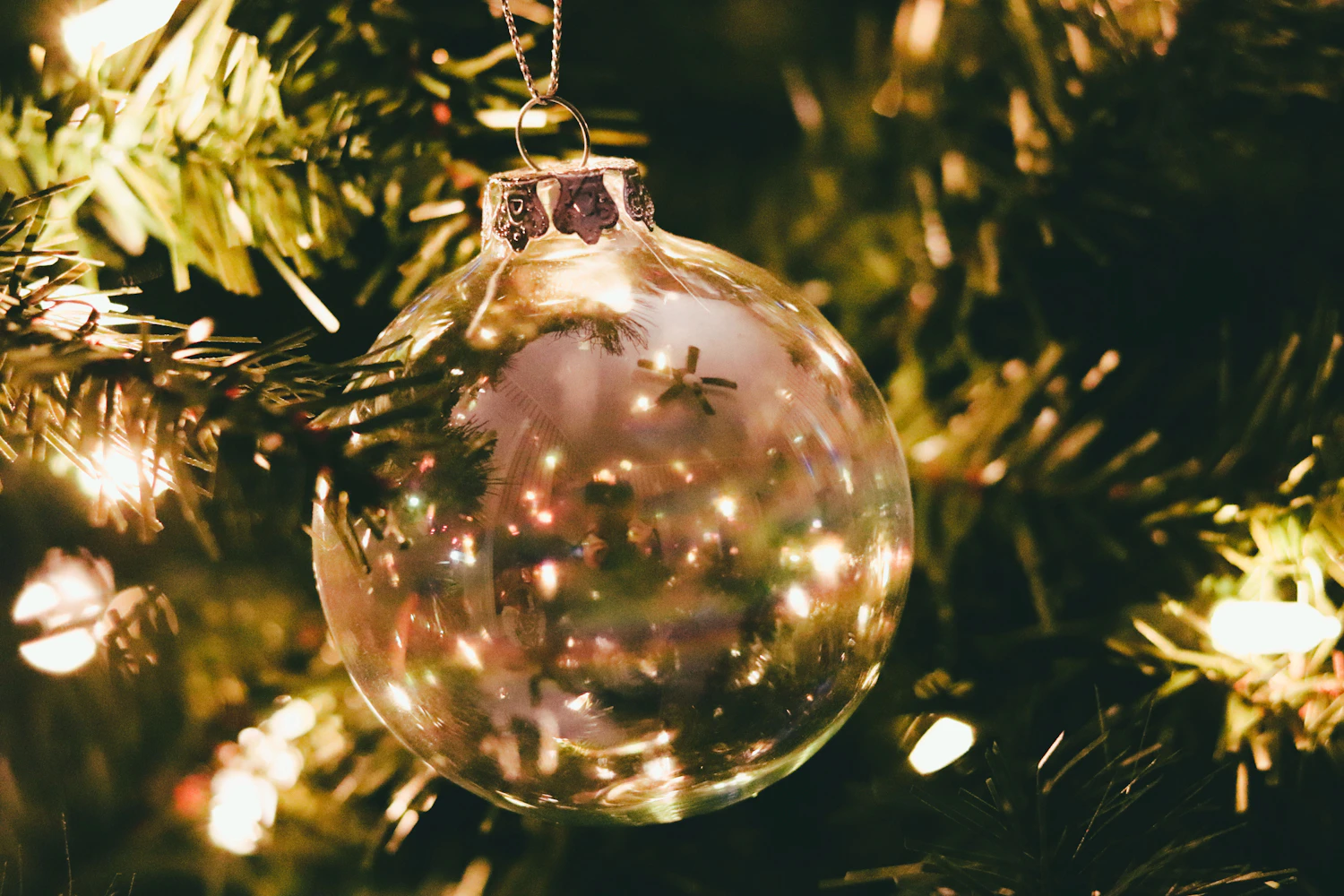 Eiskristall clear glass bauble reflecting fairy lights on a fir tree